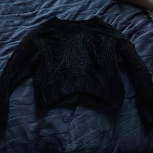 Black textured cropped sweater.